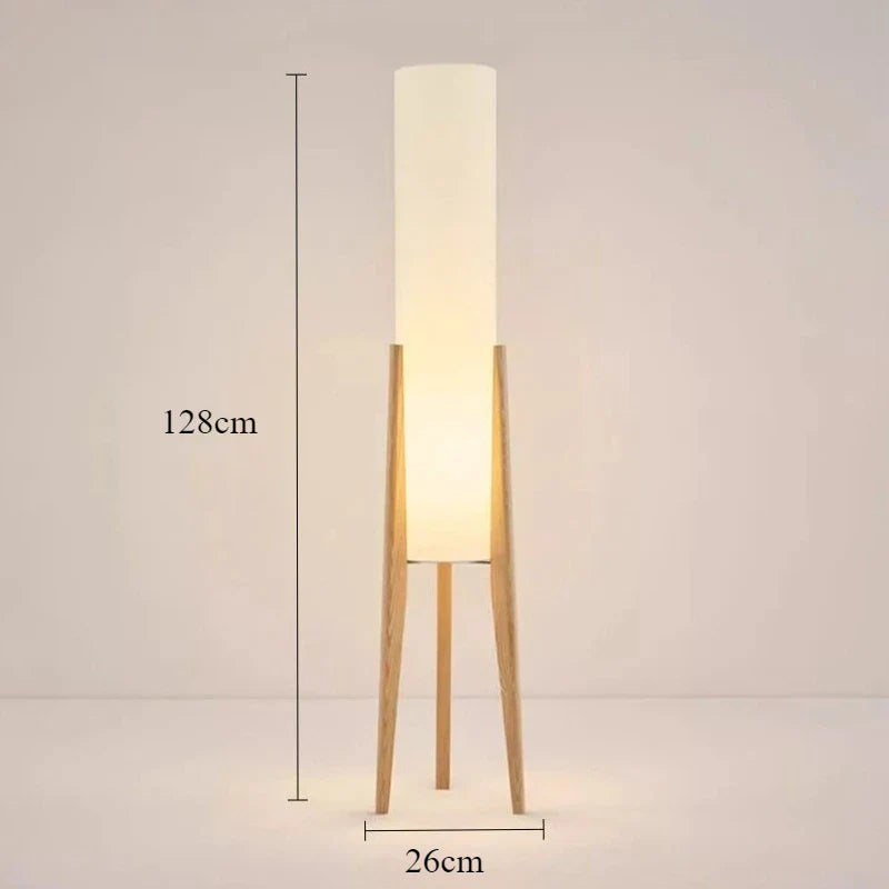 Modern floor lamp with wooden legs and a cylindrical shade
