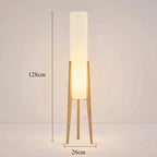 Modern floor lamp with wooden legs and a cylindrical shade