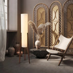 Modern floor lamp with wooden legs and a cylindrical shade