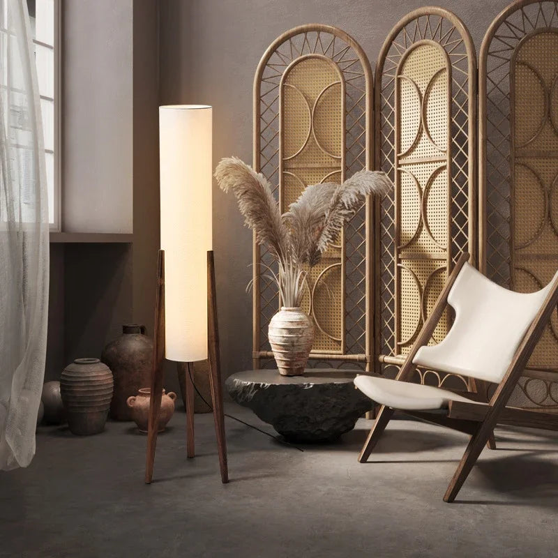 Modern floor lamp with wooden legs and a cylindrical shade