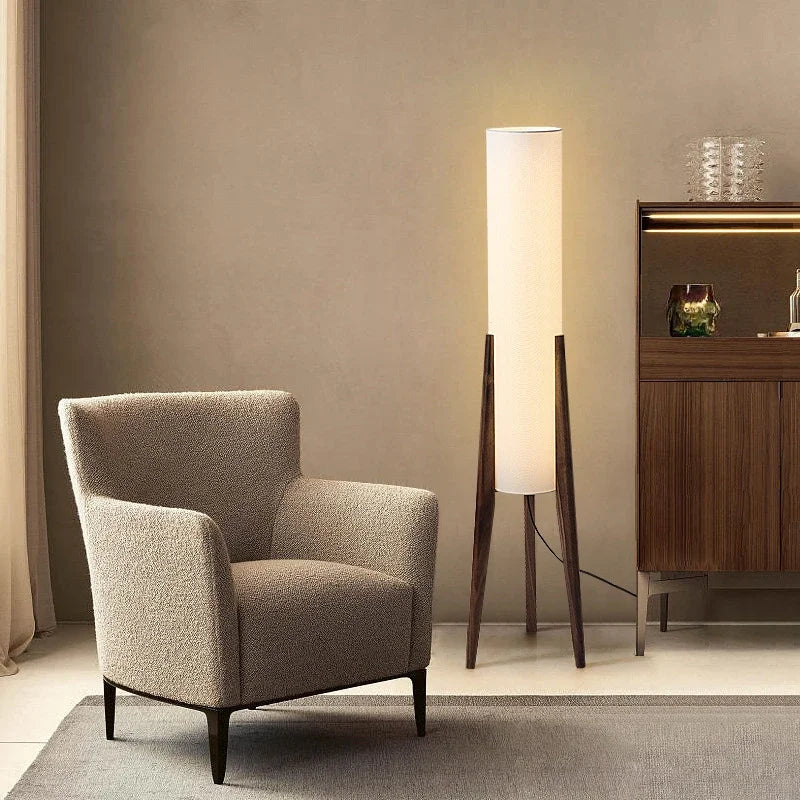 Modern floor lamp with wooden legs and a cylindrical shade
