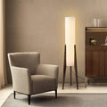Modern floor lamp with wooden legs and a cylindrical shade