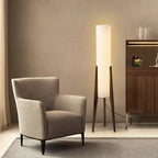 Modern floor lamp with wooden legs and a cylindrical shade