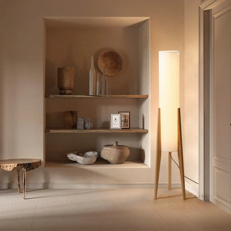 Modern floor lamp with wooden legs and a cylindrical shade