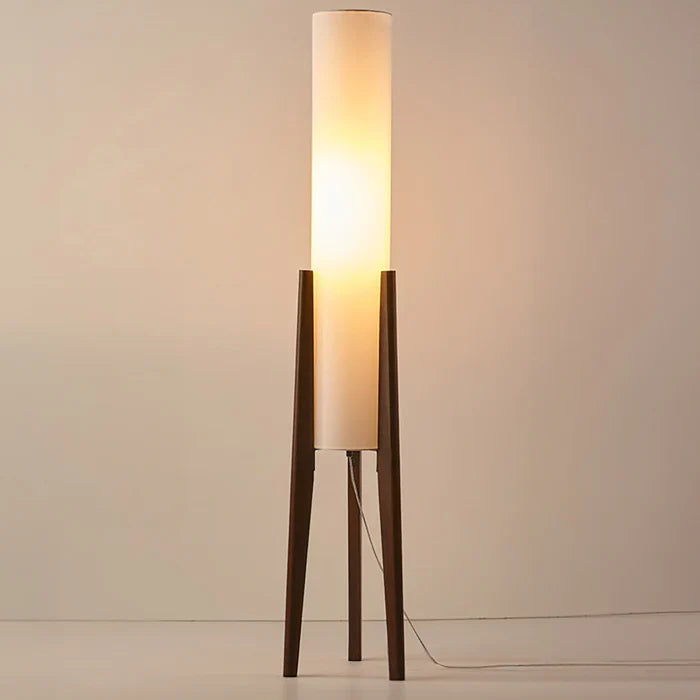 Modern floor lamp with wooden legs and a cylindrical shade