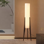 Modern floor lamp with wooden legs and a cylindrical shade