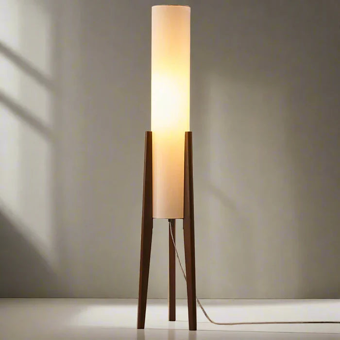 Modern floor lamp with wooden legs and a cylindrical shade