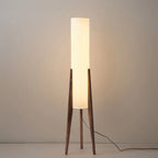 Modern floor lamp with wooden legs and a cylindrical shade