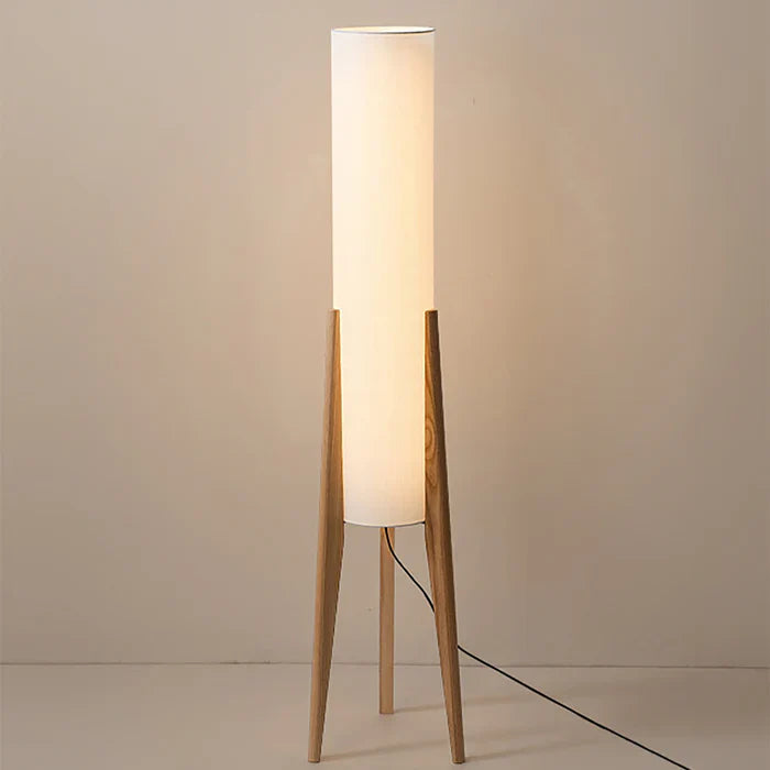 Modern floor lamp with wooden legs and a cylindrical shade