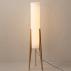 Modern floor lamp with wooden legs and a cylindrical shade