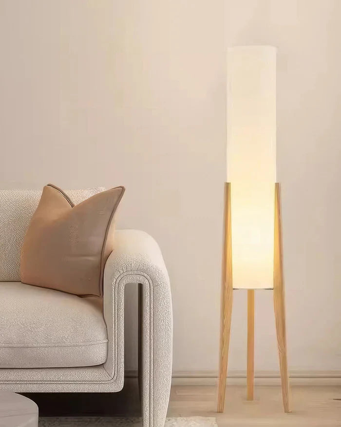 Modern floor lamp with wooden legs and a cylindrical shade